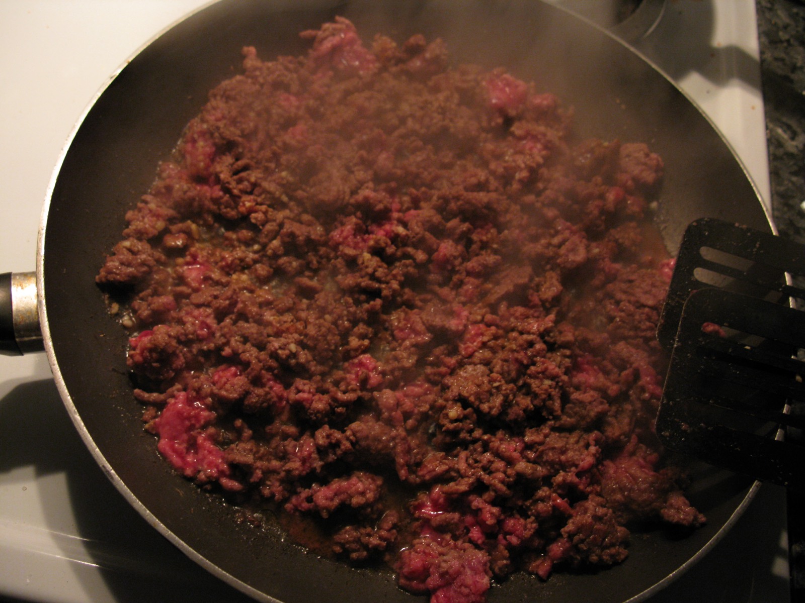 Ground meat browning in a pan