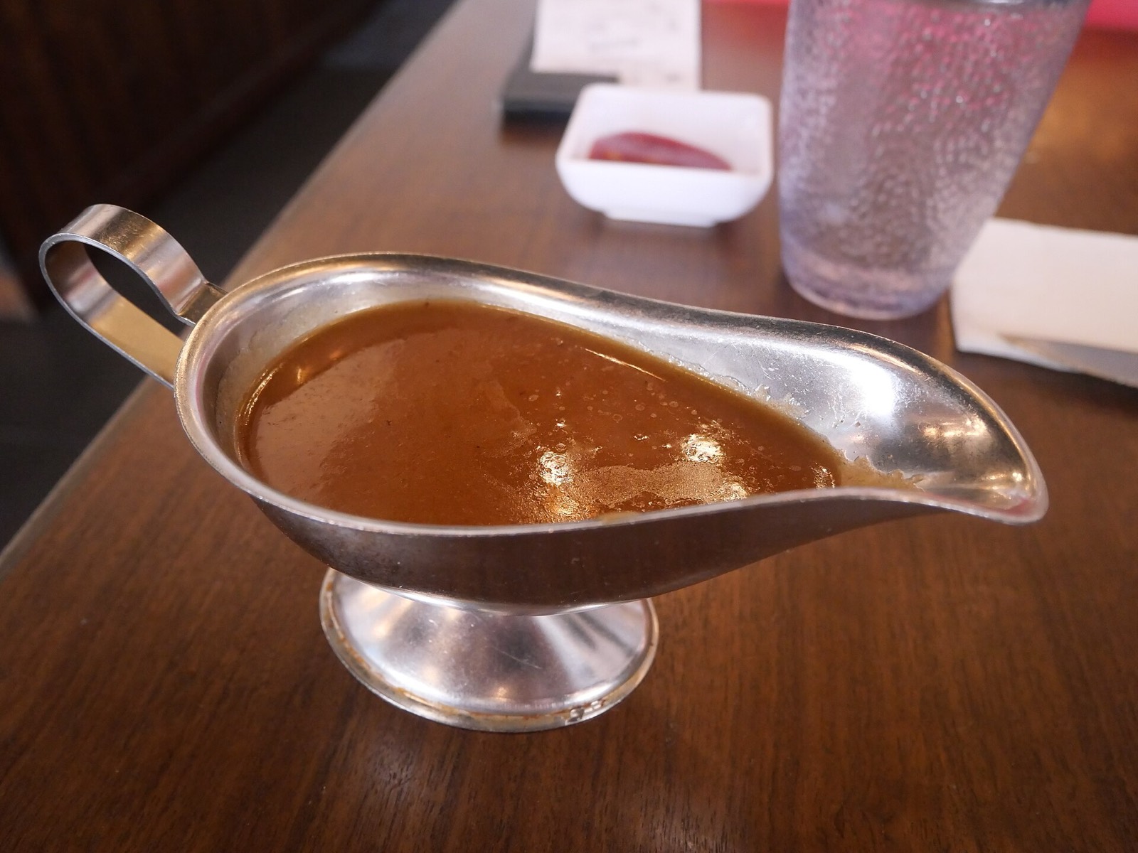 A gravy boat filled with brown gravy