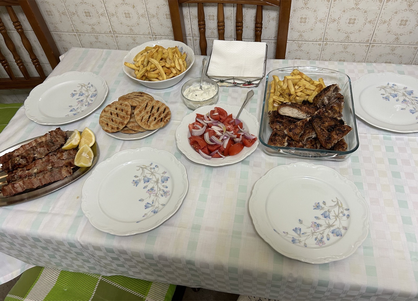 A generous spread of Greek dishes on a family table