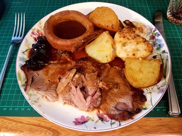 A roast leg of lamb with golden potatoes