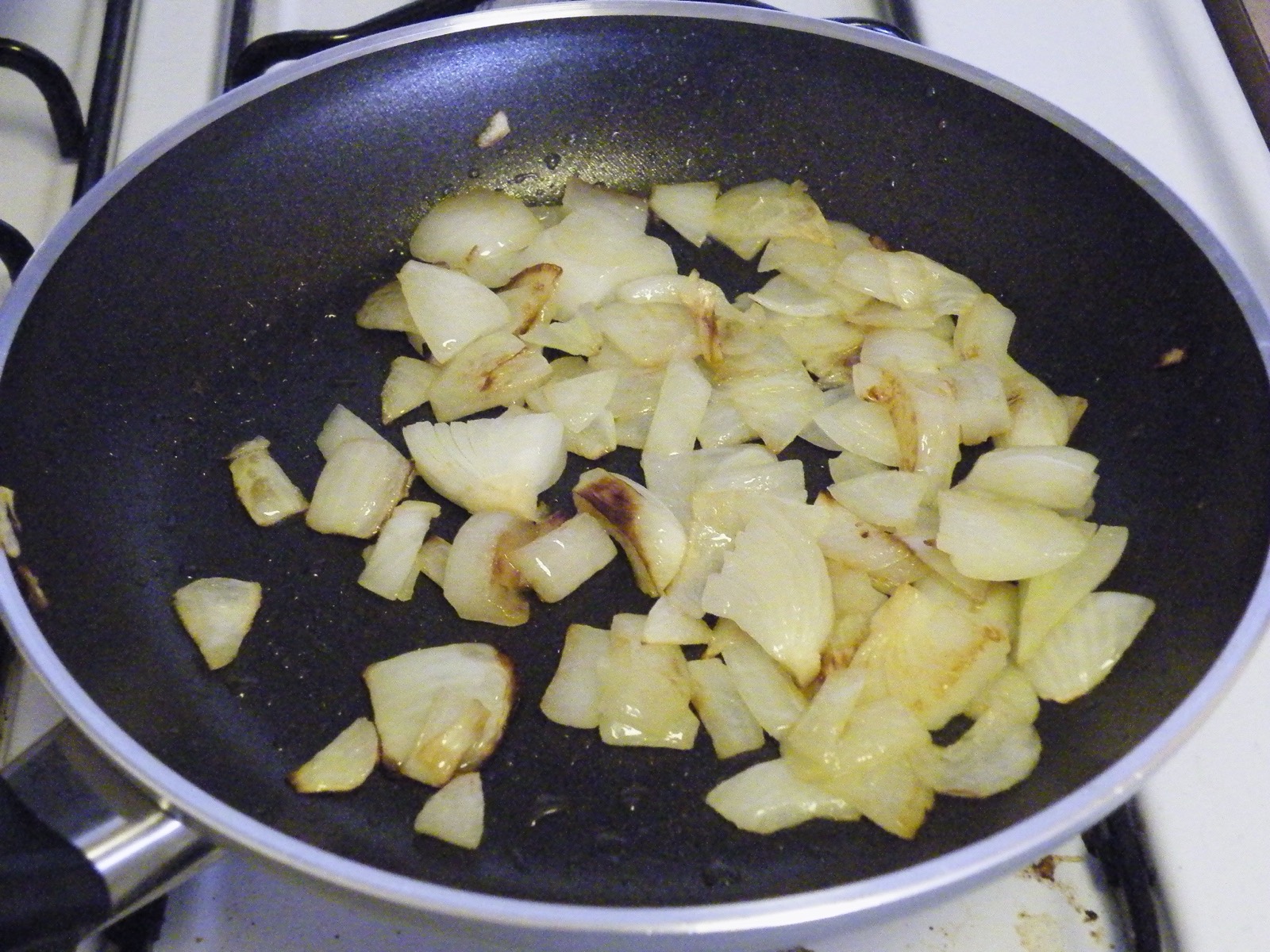 Onions softening in a hot pan