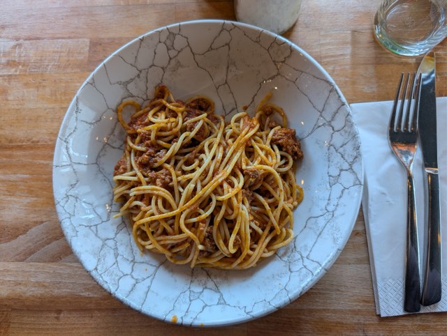 Spaghetti topped with meat and tomato sauce