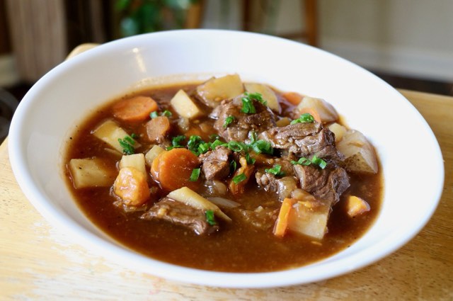 A bowl of paprika beef stew with carrots and potatoes