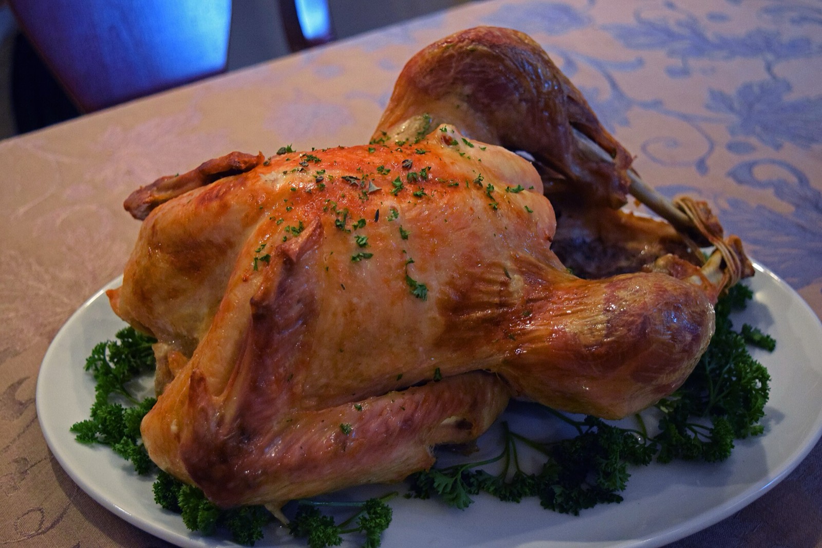 A whole roasted turkey, browned and ready to carve