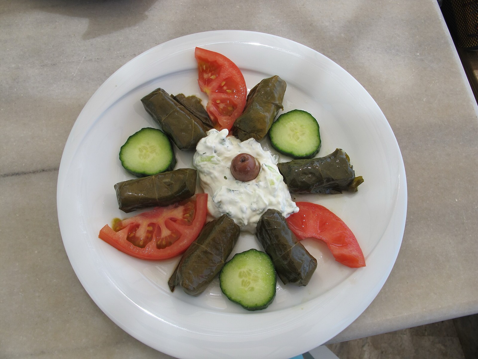 Stuffed grapevine leaves (dolmades) arranged on a plate